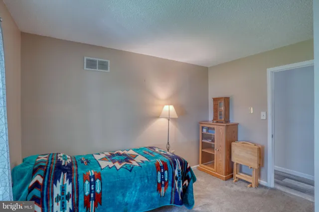 a bedroom with a bed and a table in it