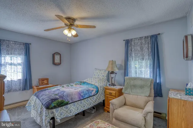 a bedroom with a bed a couch and a window