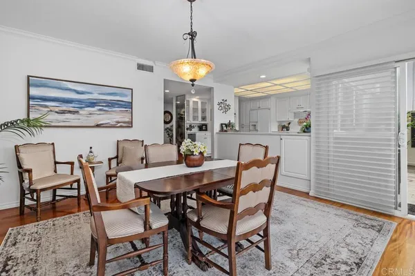 a view of a dining room with furniture and wooden floor