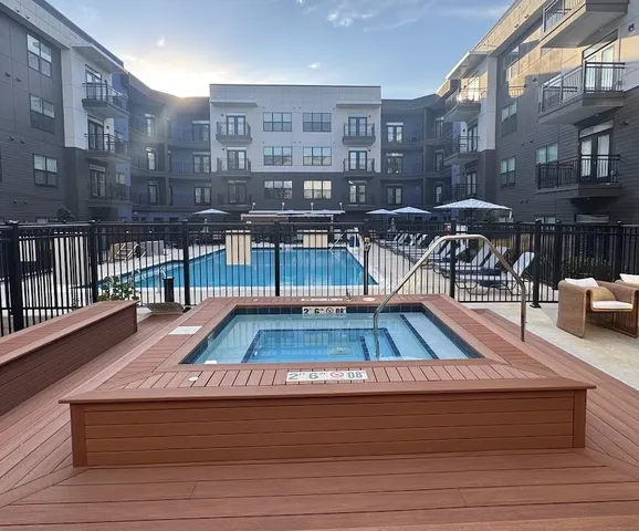 a view of a roof deck with table and chairs