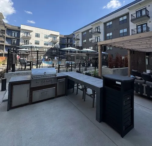 a view of a swimming pool and lounge chairs in patio