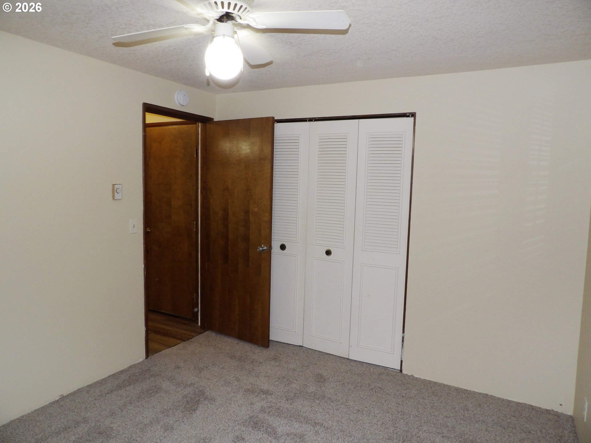 3124 19th Place Forest Grove, OR 97116 - Photo 25 of 31 an empty room with windows and fan