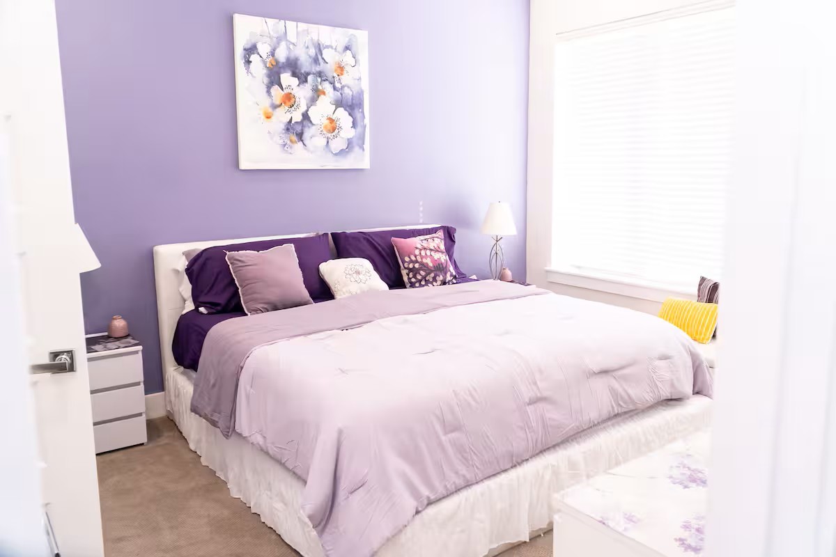 2105 Engelmohr Street, Unit A Houston, TX 77054 - Photo 13 of 16 a large bed sitting in a bedroom next to a bathroom sink and a mirror