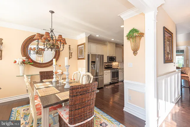 a living room with furniture a fireplace a flat screen tv and a window