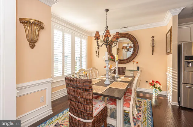 a living room with furniture a fireplace and a large window