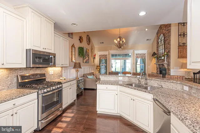 a living room with furniture and floor to ceiling windows