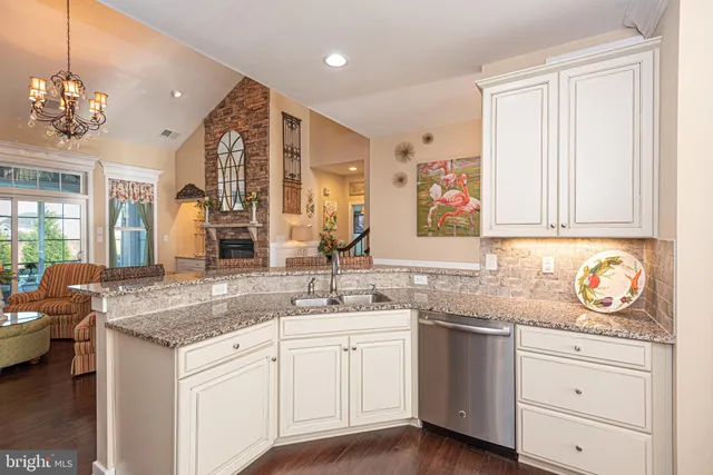 a bathroom with a granite countertop sink mirror vanity and toilet