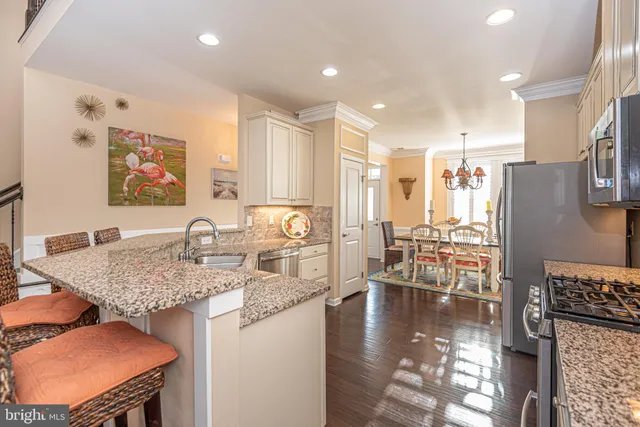 a spacious bathroom with a granite countertop sink a toilet and a mirror