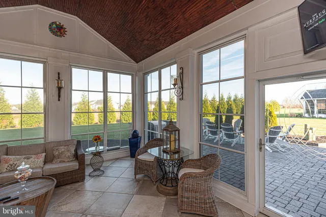 a living room with furniture a couch and a window