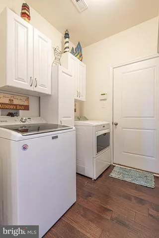 an aerial view of a house with a garden and lake view