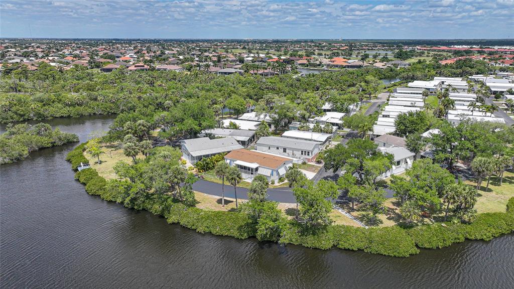 10303 Burnt Store Road, Unit 143 Punta Gorda, FL 33950 - Photo 34 of 42 an aerial view of a house with a yard and lake view