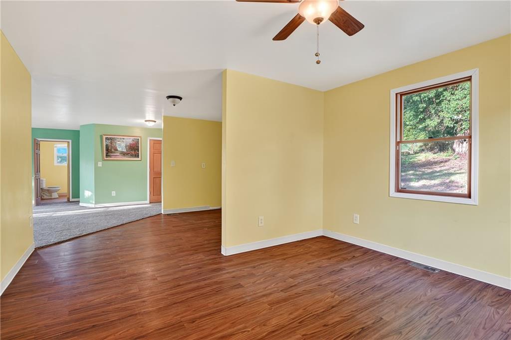 208 McCleary Road Aliquippa, PA 15001 - Photo 18 of 45 a view of an empty room with wooden floor and a window