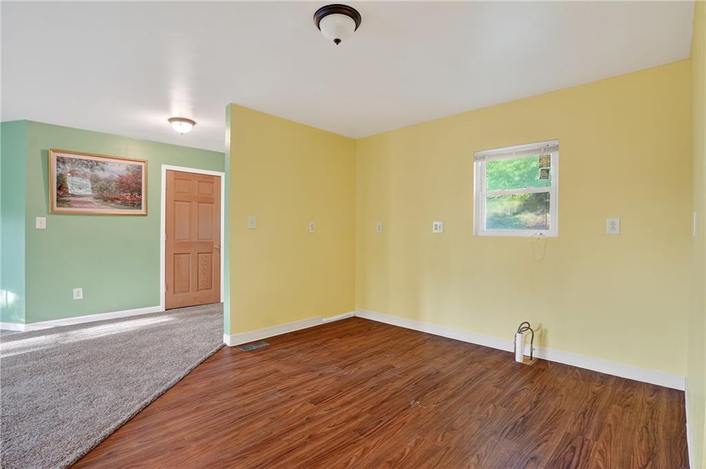 208 McCleary Road Aliquippa, PA 15001 - Photo 19 of 45 a view of an empty room with wooden floor and a window