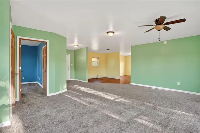 a view of a big room with closet and windows