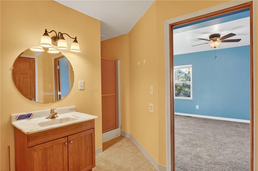 208 McCleary Road Aliquippa, PA 15001 - Photo 35 of 45 a bathroom with a sink a mirror and a vanity