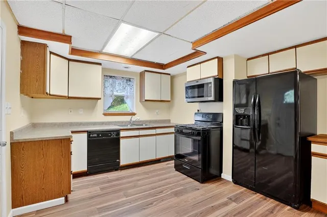 a kitchen with stainless steel appliances granite countertop a refrigerator stove and sink
