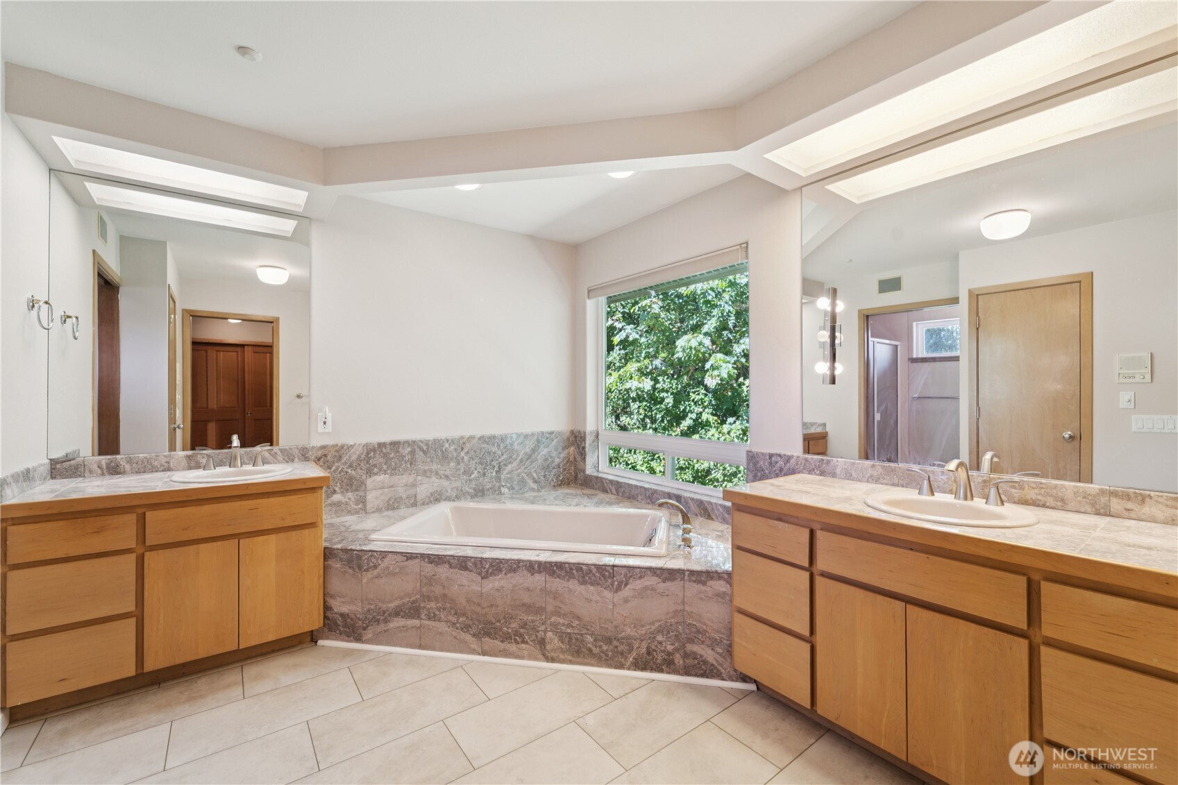 19749 53rd Avenue Northeast Lake Forest Park, WA 98155 - Photo 16 of 35 a spacious bathroom with a tub sink and mirror