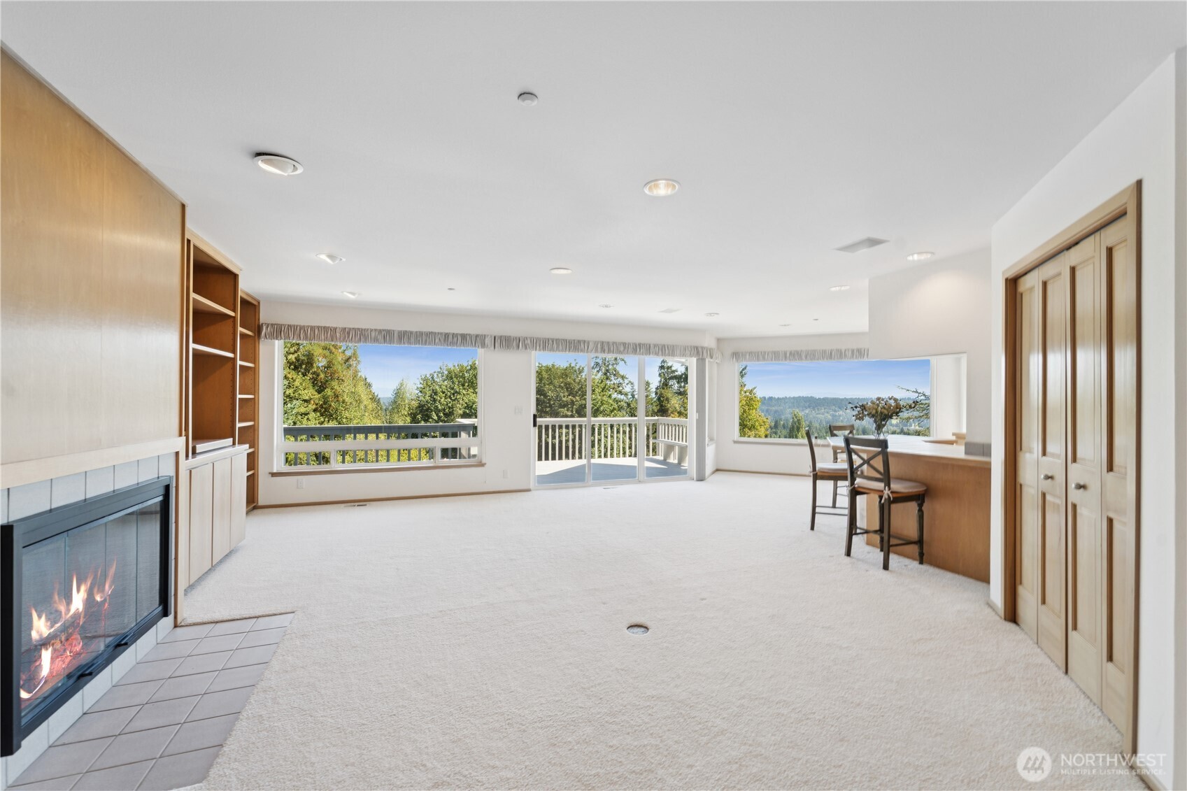 19749 53rd Avenue Northeast Lake Forest Park, WA 98155 - Photo 3 of 35 a view of an empty room with a fireplace and a large window