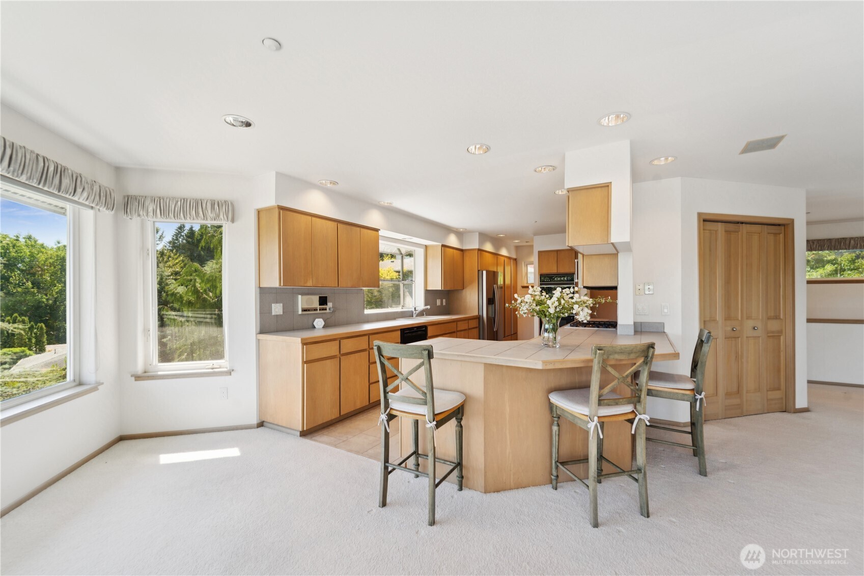 19749 53rd Avenue Northeast Lake Forest Park, WA 98155 - Photo 9 of 35 a kitchen with a sink and chairs