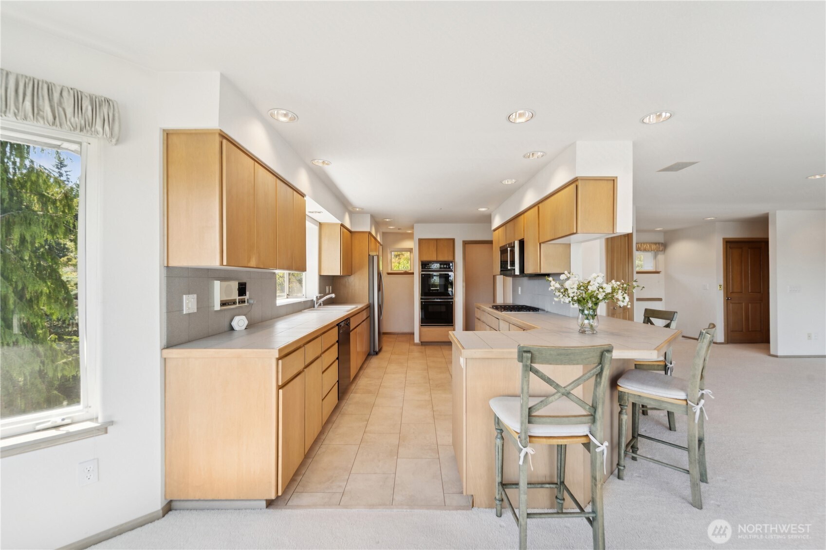 19749 53rd Avenue Northeast Lake Forest Park, WA 98155 - Photo 10 of 35 a large kitchen with a table and chairs