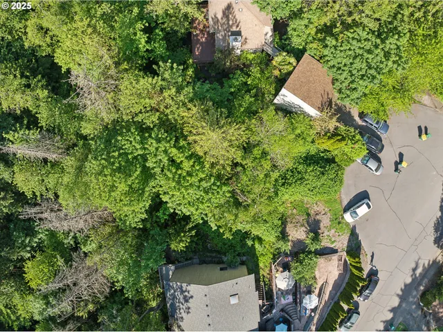 an aerial view of a house with a yard and outdoor seating
