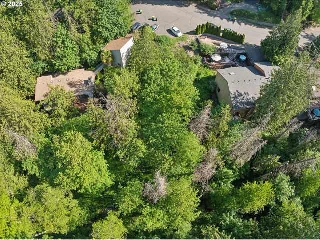 an aerial view of a house with a yard and trees