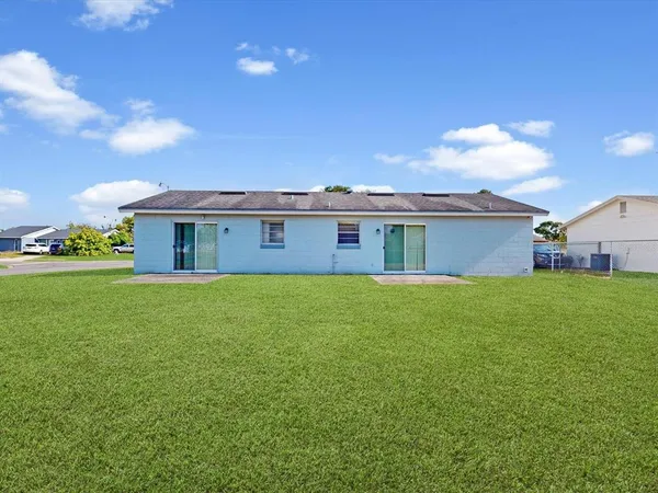 a view of a house with a backyard