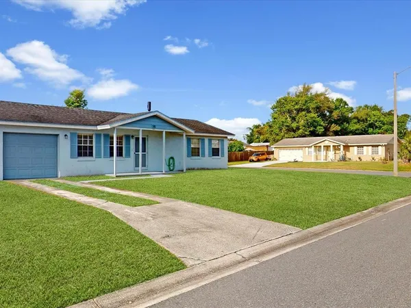 a front view of a house with a yard table and chairs