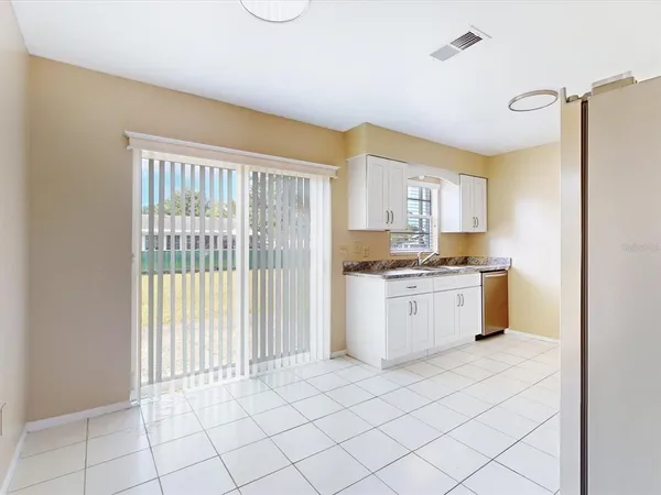 a kitchen with a stove a sink and a refrigerator