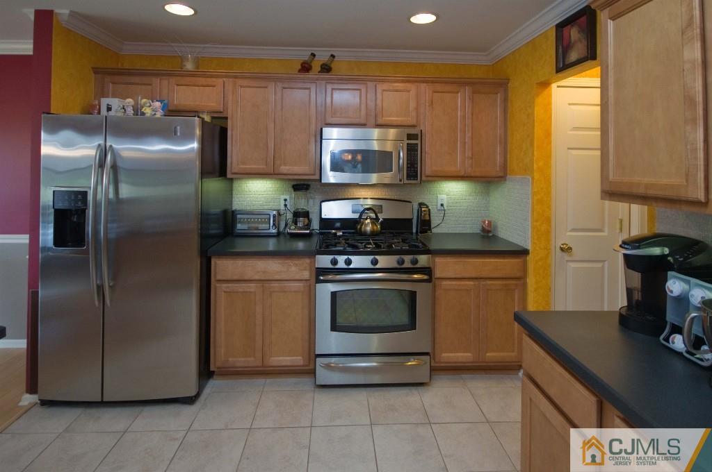 11 Raritan Reach Road South Amboy, NJ 08879 - Photo 6 of 20 a kitchen with stainless steel appliances granite countertop a refrigerator a stove and a sink