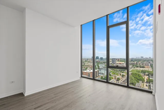 an empty room with wooden floor and closet