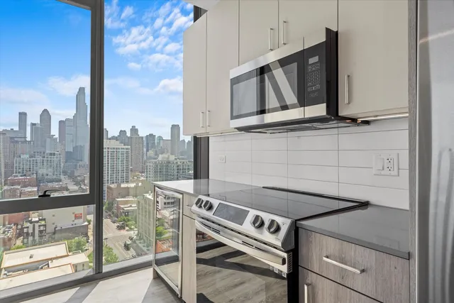 a kitchen with granite countertop a sink and a refrigerator