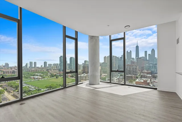 a room with a large window and furniture