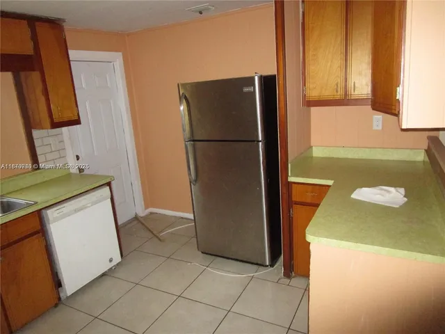 a kitchen with a refrigerator sink and stove