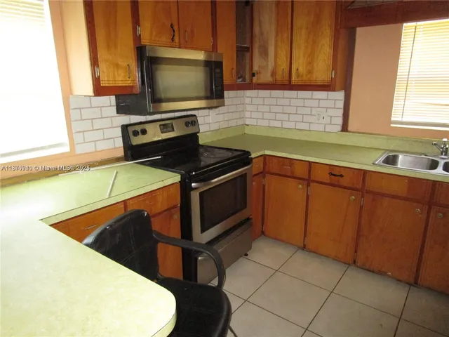 a kitchen with a stove and a microwave
