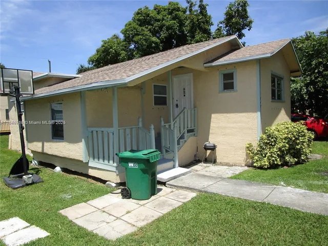 a view of a house with a yard and plants