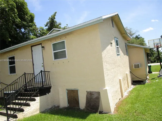 a view of a house with backyard and sitting area