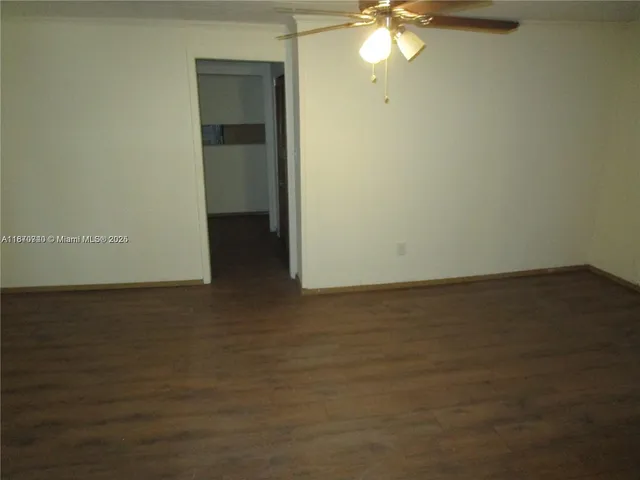 a view of a room with wooden floor and fan