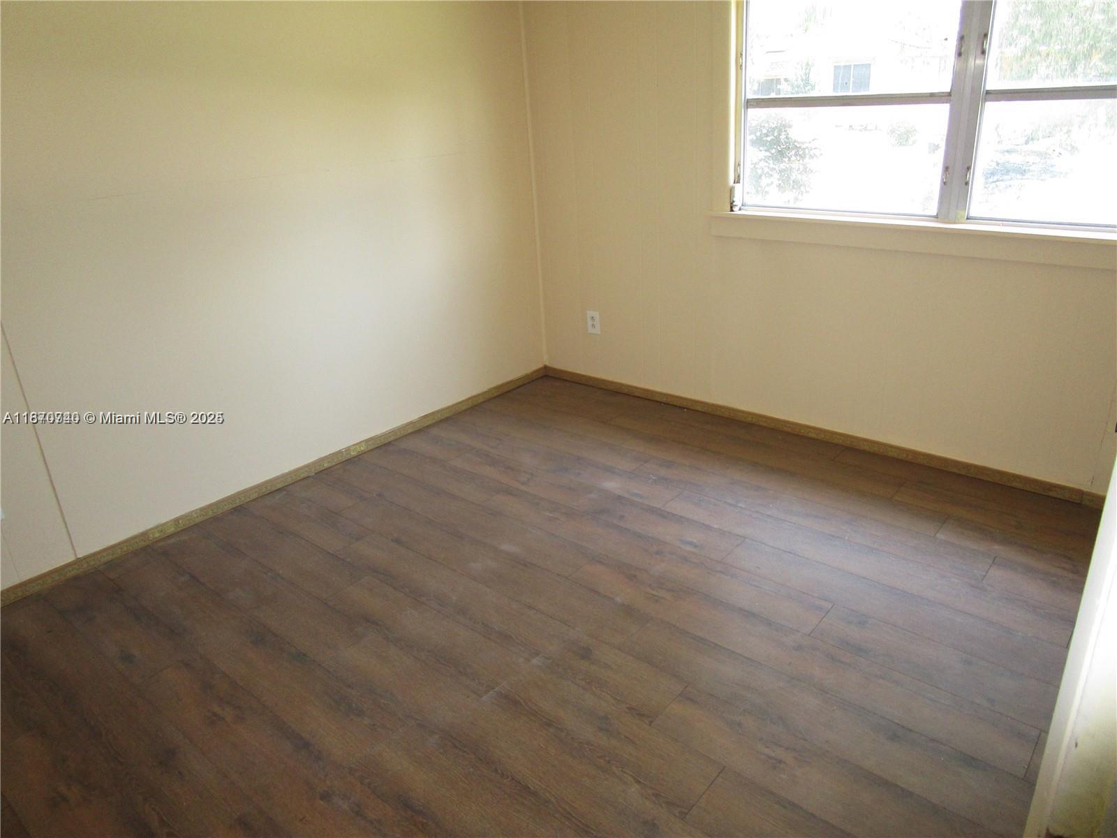 349 Cypress Avenue Pahokee, FL 33476 - Photo 6 of 15 an empty room with a window