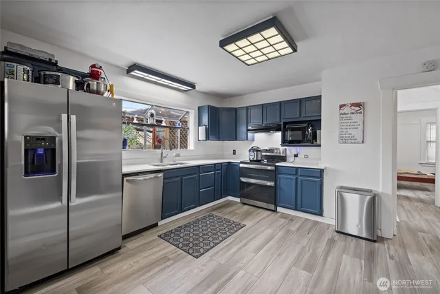 a kitchen with granite countertop stainless steel appliances and wooden cabinets