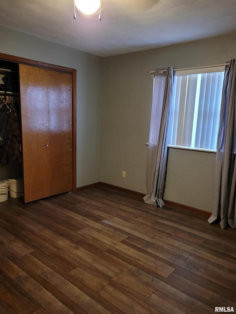 469 Main Street Radom, IL 62808 - Photo 12 of 23 a view of an empty room with wooden floor and a window