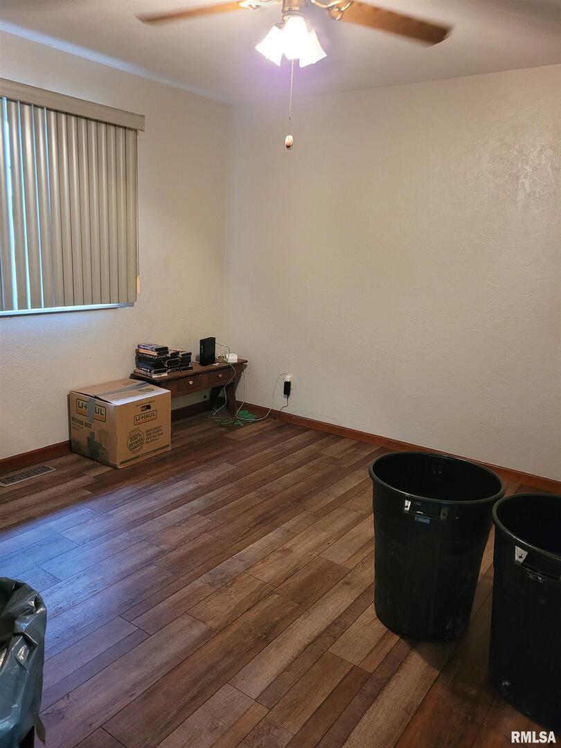 469 Main Street Radom, IL 62808 - Photo 17 of 23 a room with wooden floor and furniture