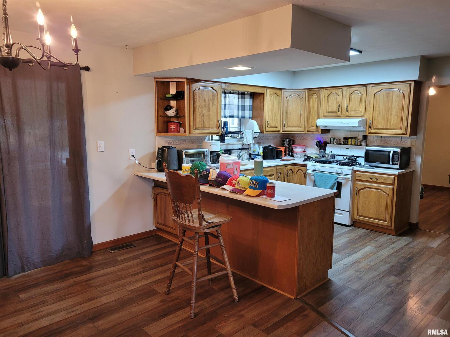 469 Main Street Radom, IL 62808 - Photo 7 of 23 a kitchen with a cabinets appliances and a dining table