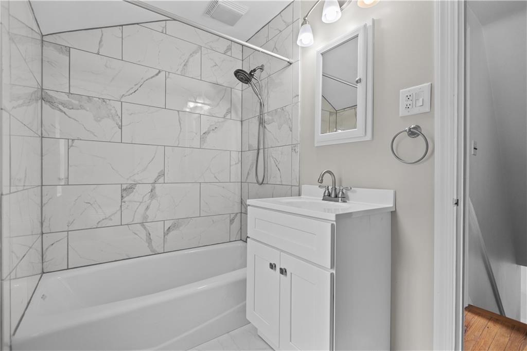 442 Serrano Avenue Pittsburgh, PA 15228 - Photo 23 of 31 a bathroom with a bathtub a sink a vanity and a shower