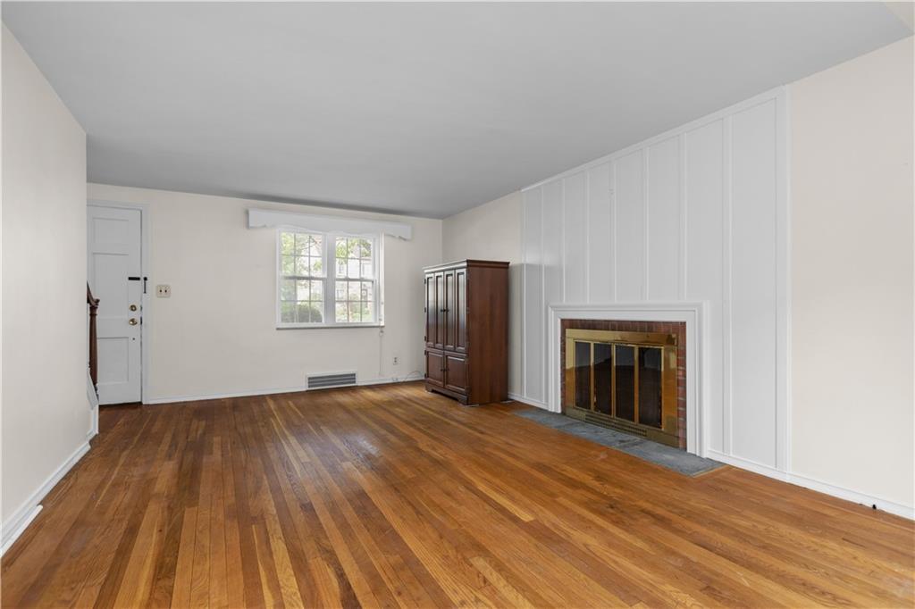 442 Serrano Avenue Pittsburgh, PA 15228 - Photo 4 of 31 wooden floor in an empty room with a fireplace