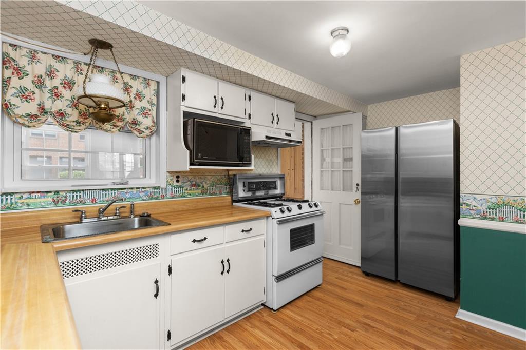 442 Serrano Avenue Pittsburgh, PA 15228 - Photo 10 of 31 a kitchen with stainless steel appliances a stove microwave and a refrigerator
