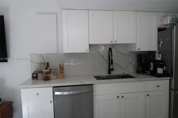 a kitchen with a sink and cabinets