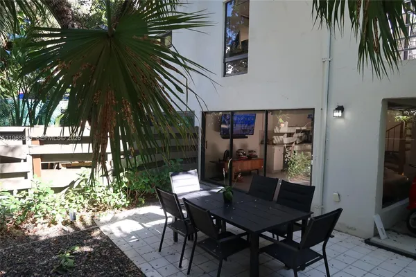 a view of a dining table and chairs in patio