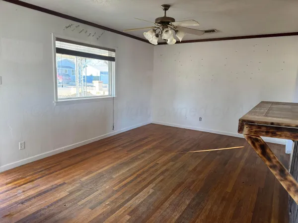 a view of a room with wooden floor and chandelier