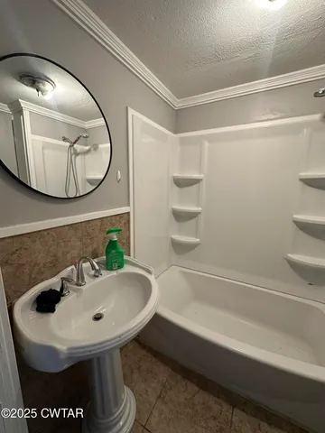 a bathroom with a sink and mirror